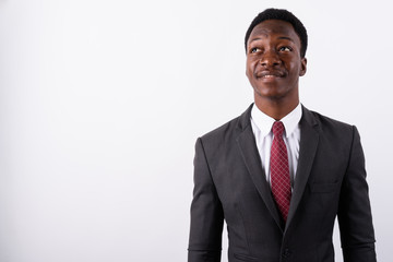 Young handsome African businessman wearing suit against white ba