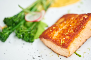 Salmon steak fillet and garnished with young broccoli. Restaurant menu, a series of photos of...