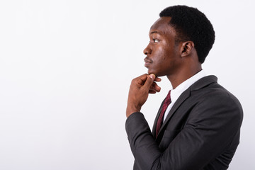 Young handsome African businessman wearing suit against white ba