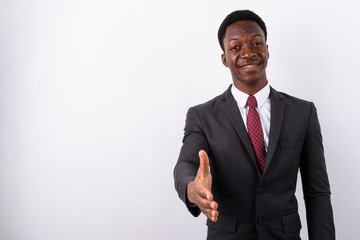 Young handsome African businessman wearing suit against white ba