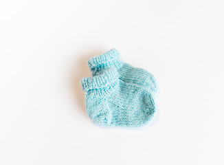 Blue handmade baby socks isolated on white background
