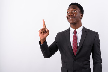 Young handsome African businessman wearing suit against white ba