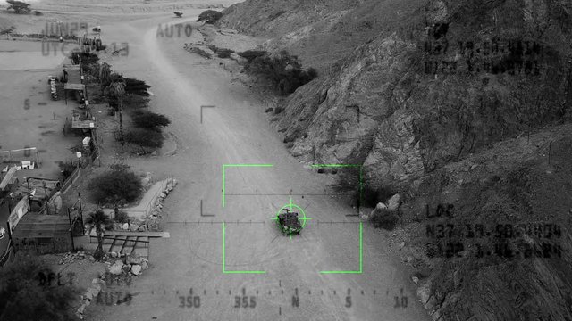 Military Drone tracking an Armed terrorist patrol Vehicle with, Night vision with dynamic tracking crosshair.