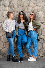 Three female friends looking between them