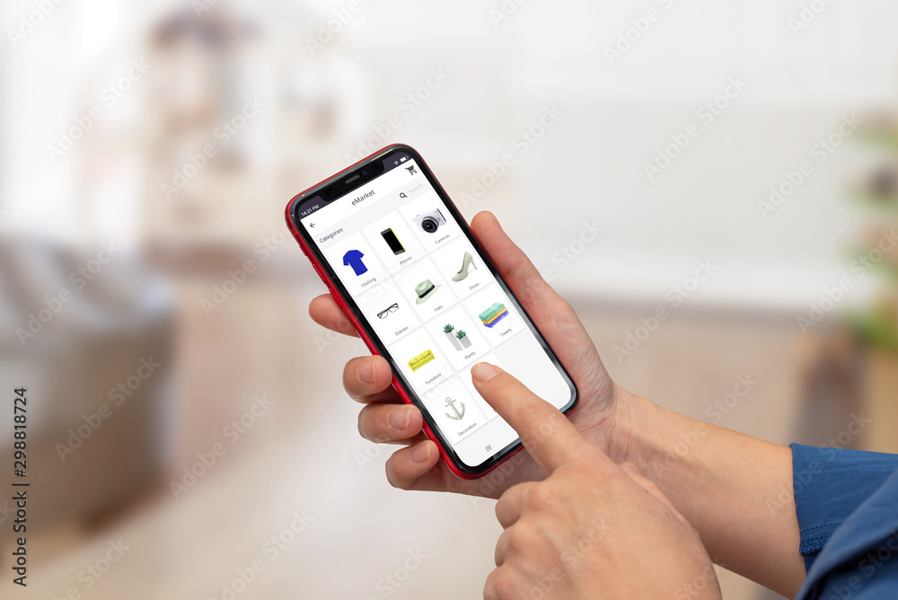 Poster Woman use online shop app on smart phone. Close-up scene with shopping app concept. Modern smart phone with round edges in hand.