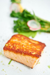 Salmon steak fillet and garnished with young broccoli. Restaurant menu, a series of photos of different dishes