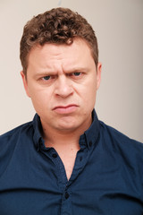 Obraz premium Studio portrait of grumpy man 