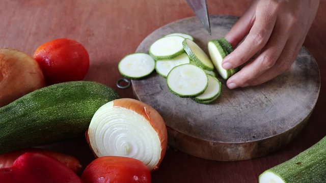 Chopping zucchini for making fresh and healthy vegetable soup