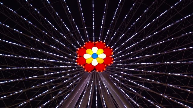 Colorful Lights In The Ferris Wheel's Center Of An Amusement Part In Vienna Prater - Tilt Up Shot