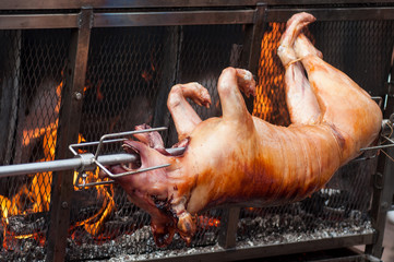 Closeup of roasted pig at the barbecue in outdoor