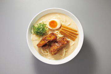 Pork cartilage ramen with bone soup in a white ceramic bowl