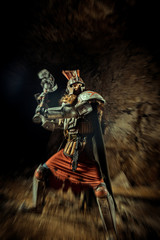 Fototapeta premium Attack of a powerful knight in the armor with the hammer. Dungeon on the background.