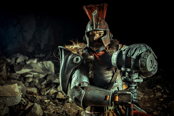 Fototapeta premium Powerful knight in the armor with the hammer. Dungeon on the background.