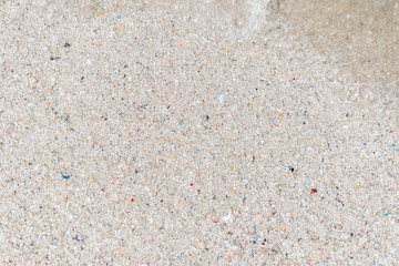 The view from the top. Summer beach, sea background of sand and clear water with foam on the ocean. The concept of vacation, vacation, travel services, background for the subject flat lay. Copy space