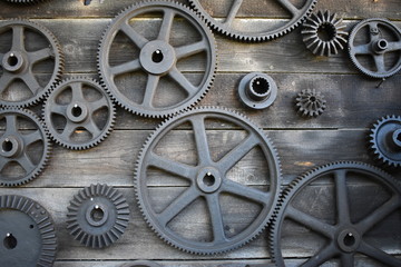 Fototapeta na wymiar Wooden wall with gears or cogwheel
