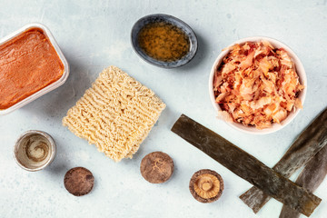 Ramen ingredients. Dried sea vegetable kelp, soba, miso paste, sake, mirin, shiitake mushrooms, shot form the top, a flat lay composition