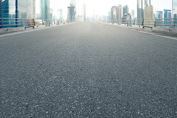 Asphalt road with modern building and skyscrapers