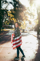 Athletic young woman with american flag. 