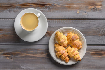 Top view of coffee and homemade cookies bagels on wooden background