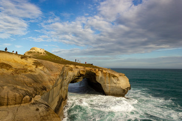 Fototapeta na wymiar Tunnel Beach - southwest of the city centre of Dunedin. Tunnel Beach has sea-carved sandstone cliffs, rock arches and caves. New Zealand, South Island