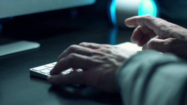 Man coder coding in computer language python on wireless computer keyboard