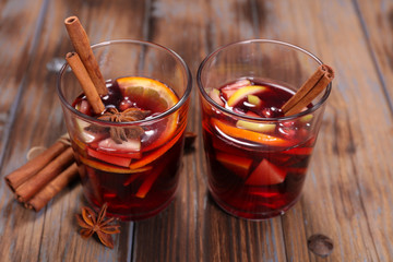 christmas mulled wine with spices on wood background