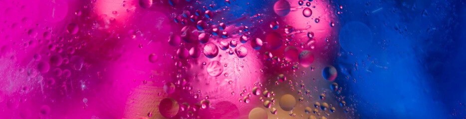 Soft focus abstract background with circles and balls. Bright pink, blue, yellow colors. Horizontal banner
