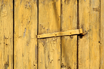 Yellow color grungy wooden planks background.