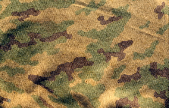 Dirty camouflage cloth with blur effect.