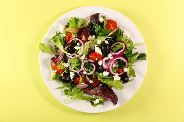 vegetable salad with tomato, cheese and onion, top view