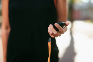 Close up of female hand holding stopwatch.