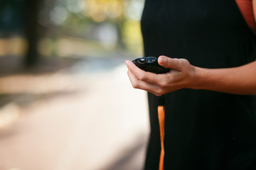 Close up of female hand holding stopwatch.