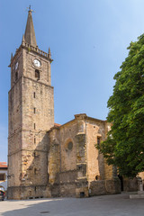 Fototapeta na wymiar Comillas, Spain. Church and Clock Tower