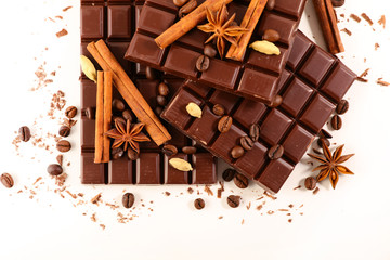 chocolate bar with spices on white background