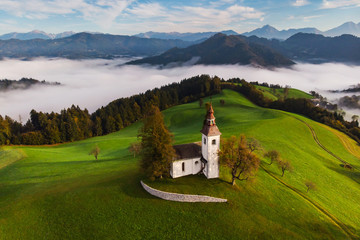 Autumn landscape of a beautiful church on the top of a hill, in Slovenia