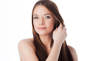 Hair care. portrait of a beautiful girl with long silky hair. Attractive young woman touches the...