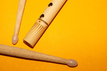 Bamboo flute and drumsticks. simple music instruments