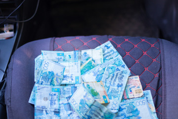 Kazakh money in a car seat