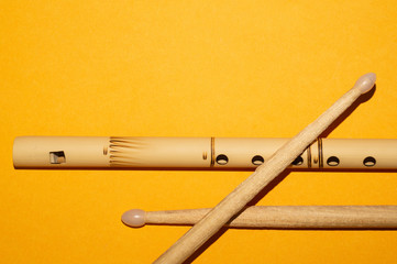 Bamboo flute and drumsticks. simple music instruments