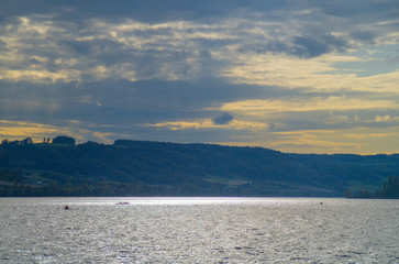 Sport rower on Lake Constance on a beautiful afternoon at the beginning of autumn in the back light.