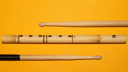 Bamboo flute and drumsticks. simple music instruments