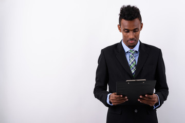 Young bearded African businessman wearing suit against white bac