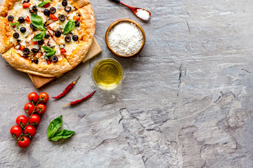 Fototapeta na wymiar Traditional italian food: pizza on grey background top view copy space