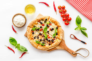 Pizza with tomato, basil, olives, cheese on white background top view