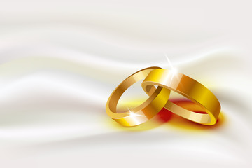 Two wedding rings on silk background