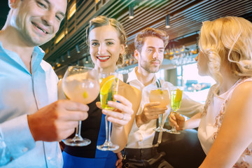 Friends enjoying the bar and drinking sugary alcoholic beverages
