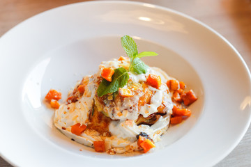 Zucchini pancakes with whipped cream, pumpkin, honey and herbs