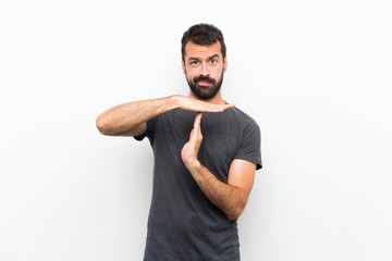 Young handsome man over isolated white background making time out gesture