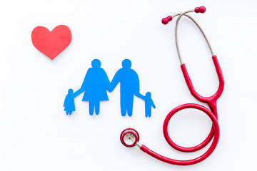 Family health care concept. Heart icon and stethoscope on white background top view