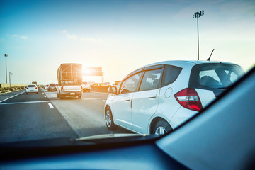 Naklejka premium Car driving on highway road,car on road and sunset background,Transportation